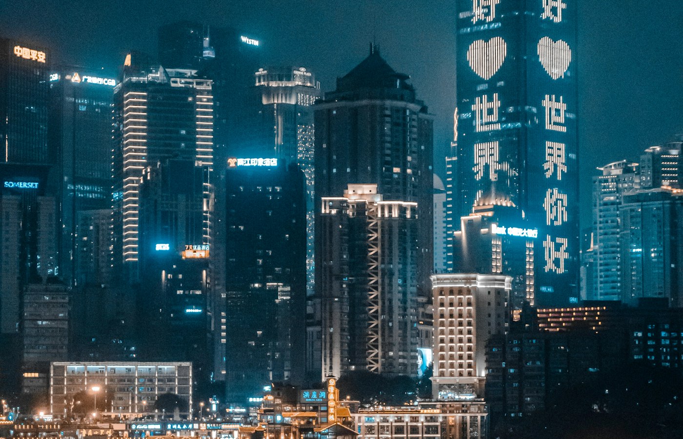 Glass towers lit up in central Chongqing at night